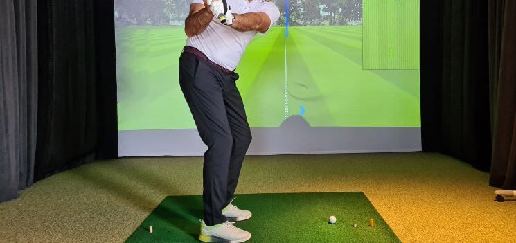 Man using a golf simulator