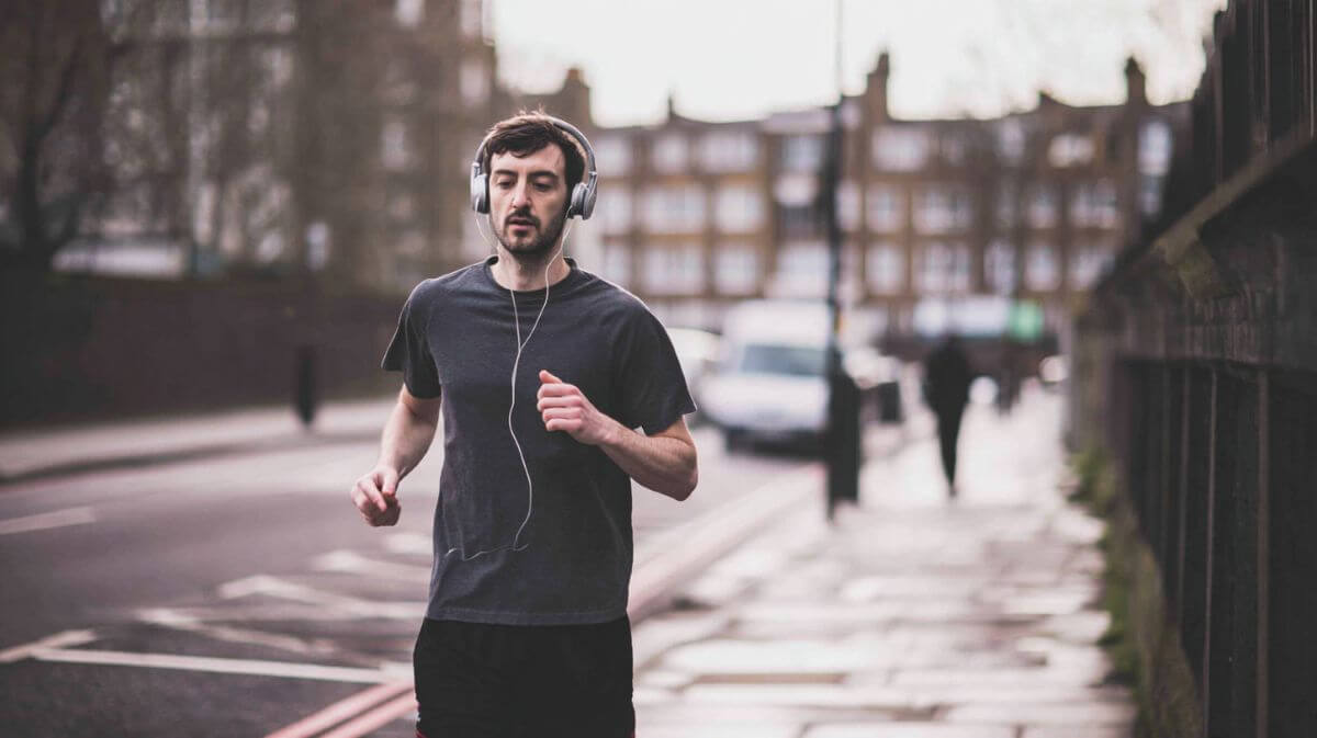 man jogging listening to music